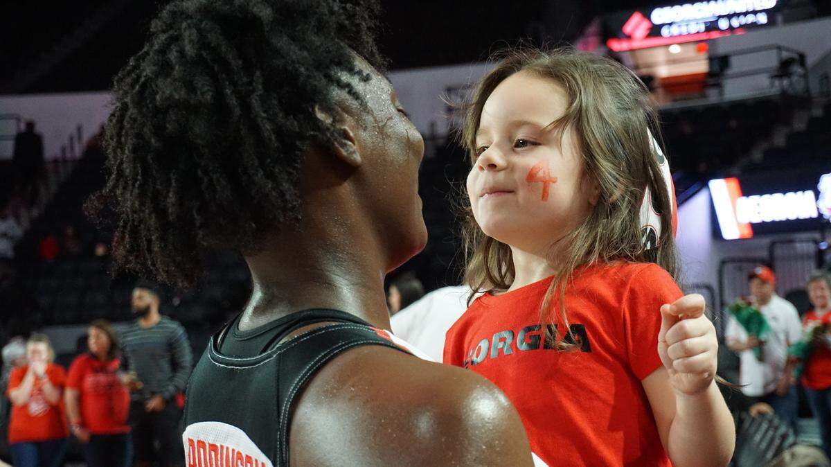 Georgia forward Caliya Robinson and her 4-year-old fan Aven share a hug after the Lady Bulldogs loss to Kentucky, 58-53.