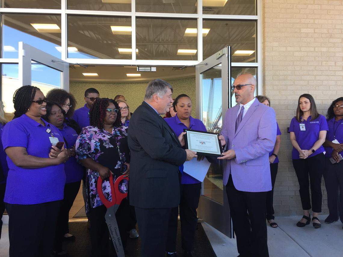 HOPE Center Director Dale Rigley awards a certificate of appreciation to Dr. Harold Katner, medical director of the HIV/AIDS clinic, at a ribbon-cutting ceremony on May 15, 2019.