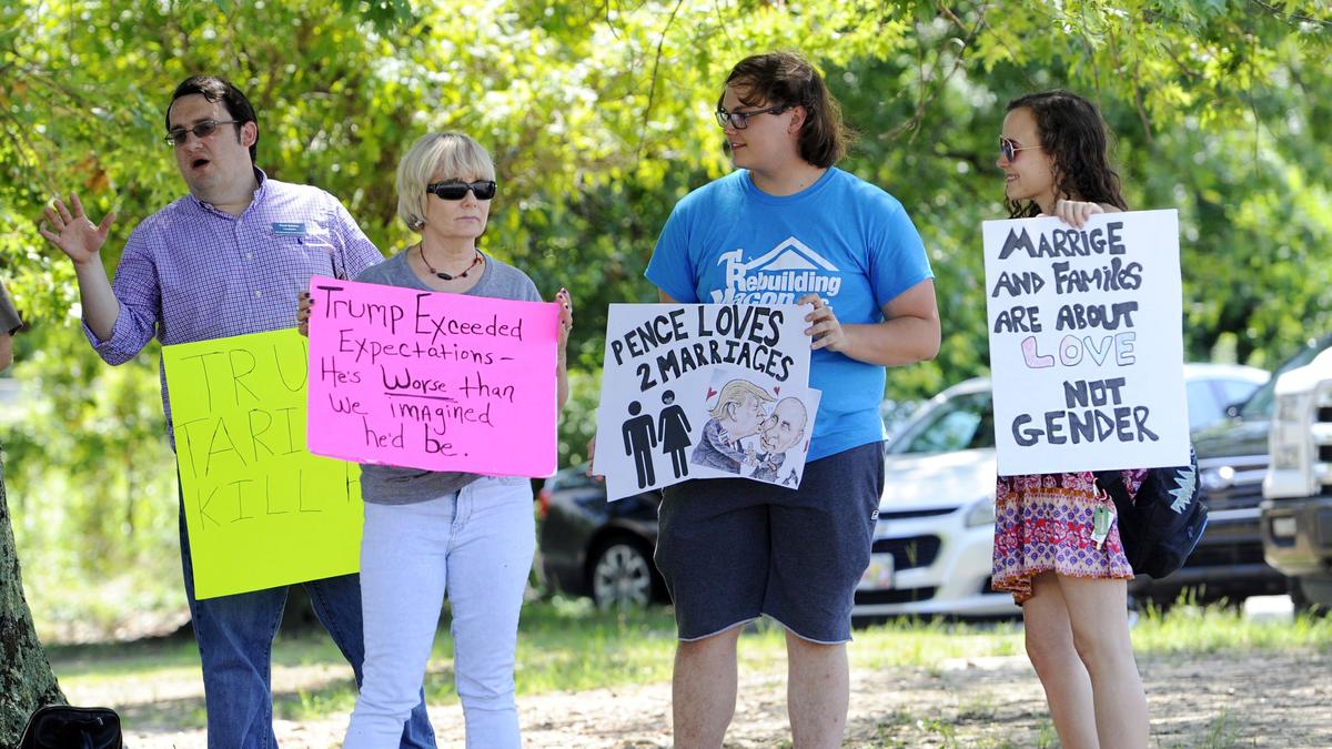 A small group of mostly Trump protestors waved their signs at passersby attending a rally for Brian Kemp Saturday at the Wilson Convention Center.