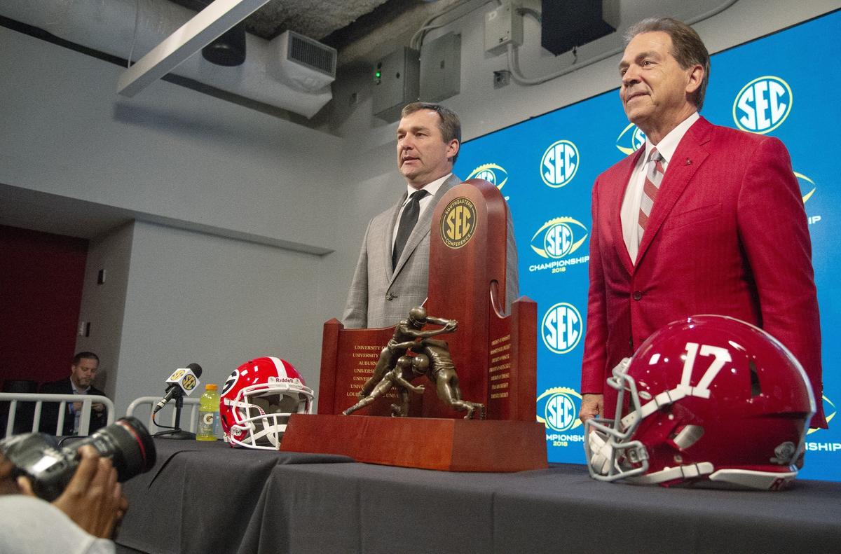 JASON VORHEES/THE TELEGRAPH Atlanta, GA, 11/30/2018:Georgia head coach Kirby Smart and Alabama head coach Nick Saban pose with the SEC Championship trophy Friday afternoon in Atlanta.