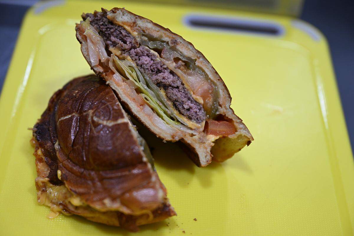 The UFO burger from Tia’s Maine Lobster Rolls is created using a press to close the bread around the meat and toppings, making a UFO shape.