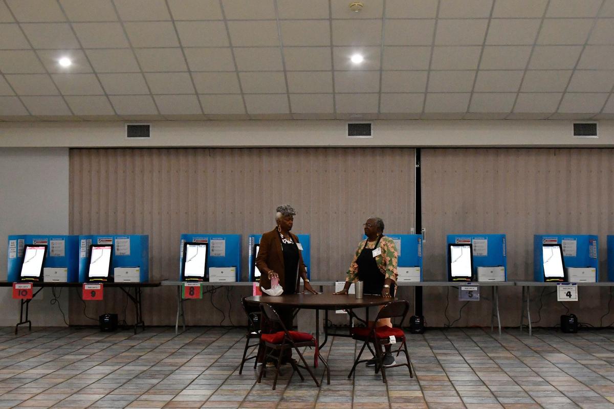Poll officers Helen Dawson (left) and Freddie Beloney talk inside of the Sweet Creek Baptist Church before polls open for the Georgia primary election on Tuesday, May 21, 2024, in Macon, Georgia. The ballot includes local races for mayor, sheriff, county commissioners and other roles as well as voting for state legislature nominations.