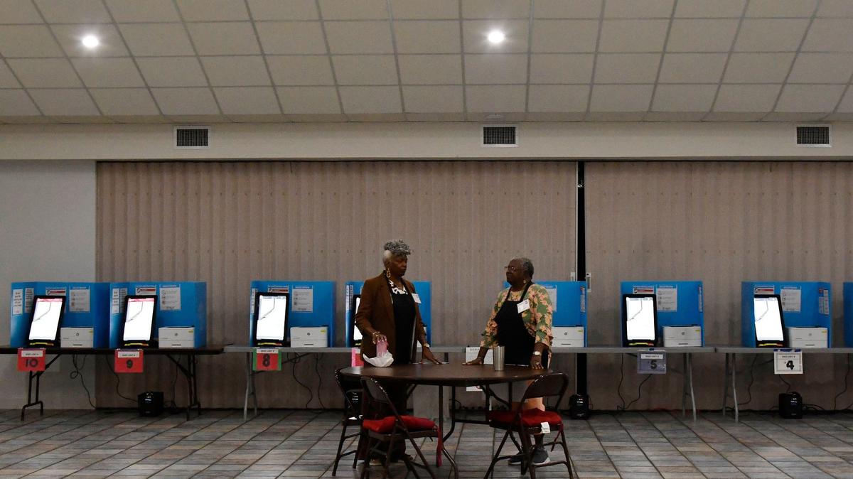 Poll officers Helen Dawson (left) and Freddie Beloney talk inside of the Sweet Creek Baptist Church before polls open for the Georgia primary election on Tuesday, May 21, 2024, in Macon, Georgia. The ballot includes local races for mayor, sheriff, county commissioners and other roles as well as voting for state legislature nominations.