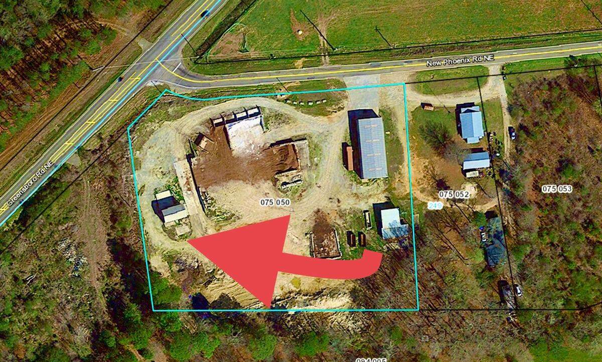 The red arrow illustrates the area where a shipping container caught fire on farmland northeast of Eatonton on Wednesday morning.