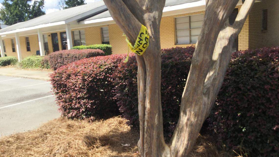 Crime scene tape wrapped around a tree Friday at Tanglewood Apartments off Elberta Road leaves a trace of a crime scene after a shooting Thursday night that residents said happened outside.