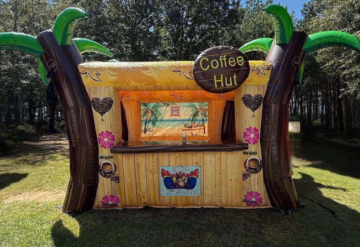 Coffee on the Moooove’s fully equipped mobile coffee cart easily sets up in an inflatable coffee hut.