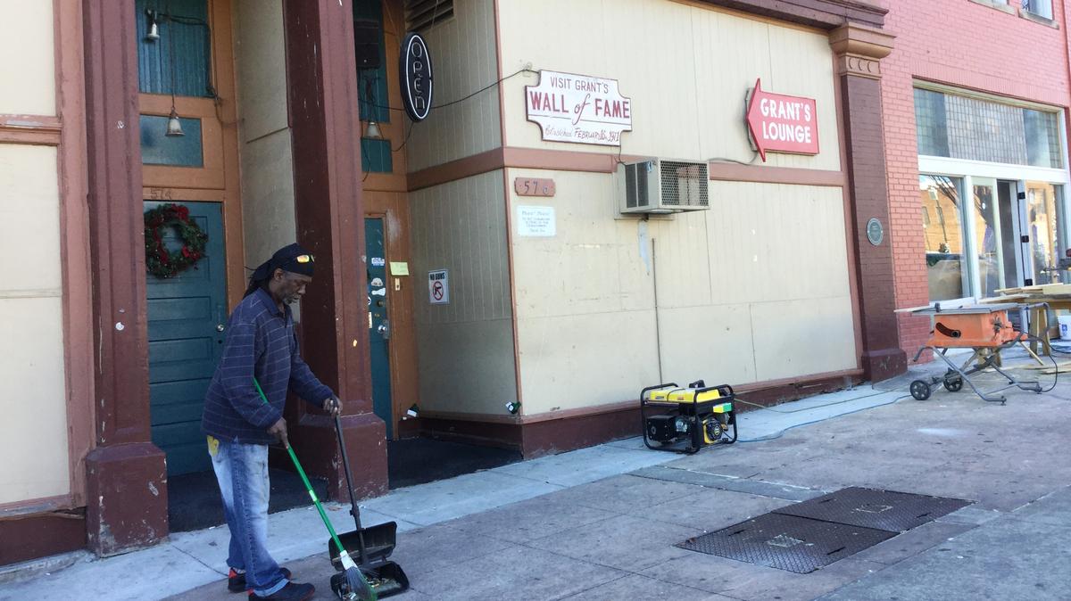 Henry Ponder sweeps outside Grant’s Lounge on Poplar Street in downtown Macon on Saturday afternoon. The popular nightclub wants to transition to a historical living museum for southern rock in the aftermath of a deadly shooting nearby.