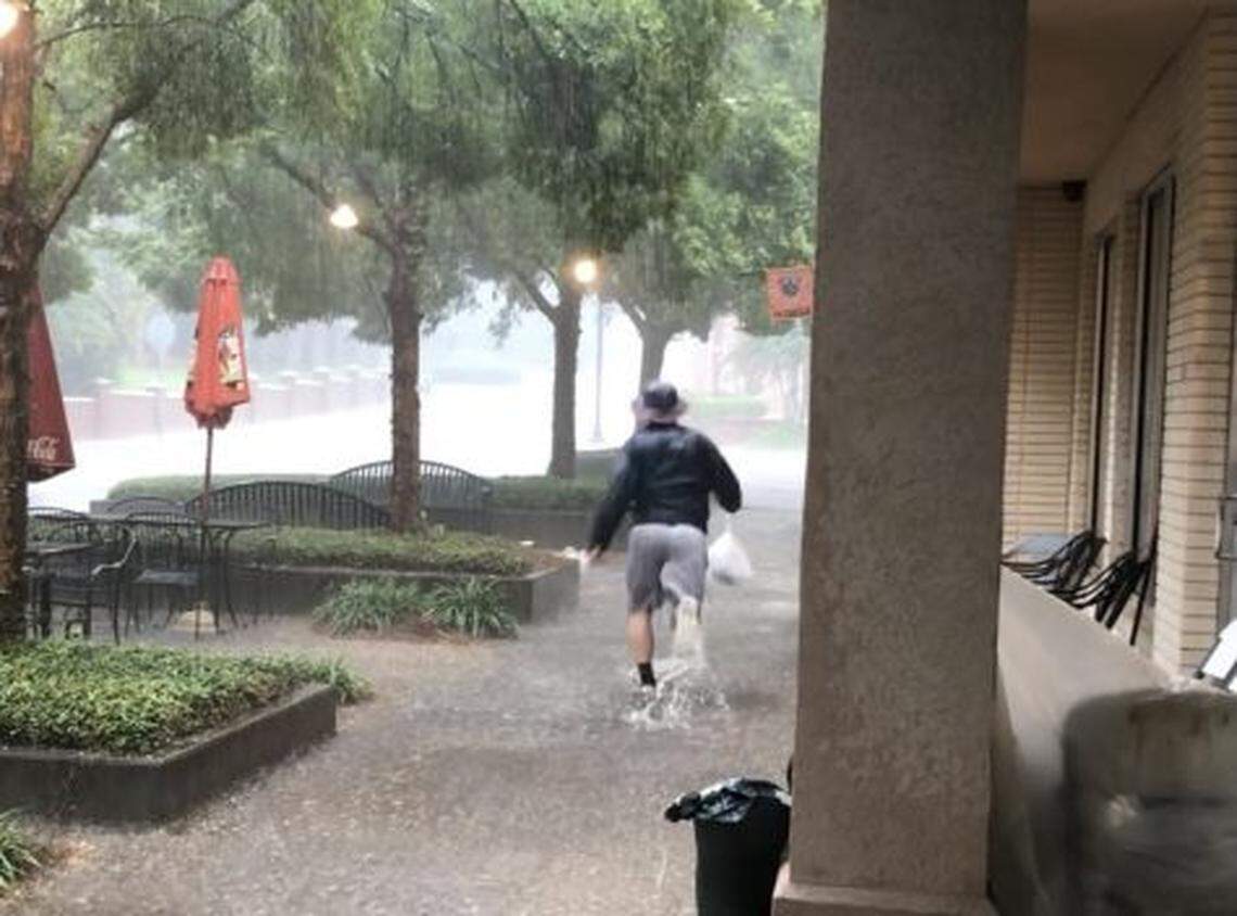 A Mercer Village patron dashes through stormwater runoff during a spring thunderstorm outside Francar’s restaurant. The Macon Water Authority responded that week and drained the sewer a couple of days after the flash flood.