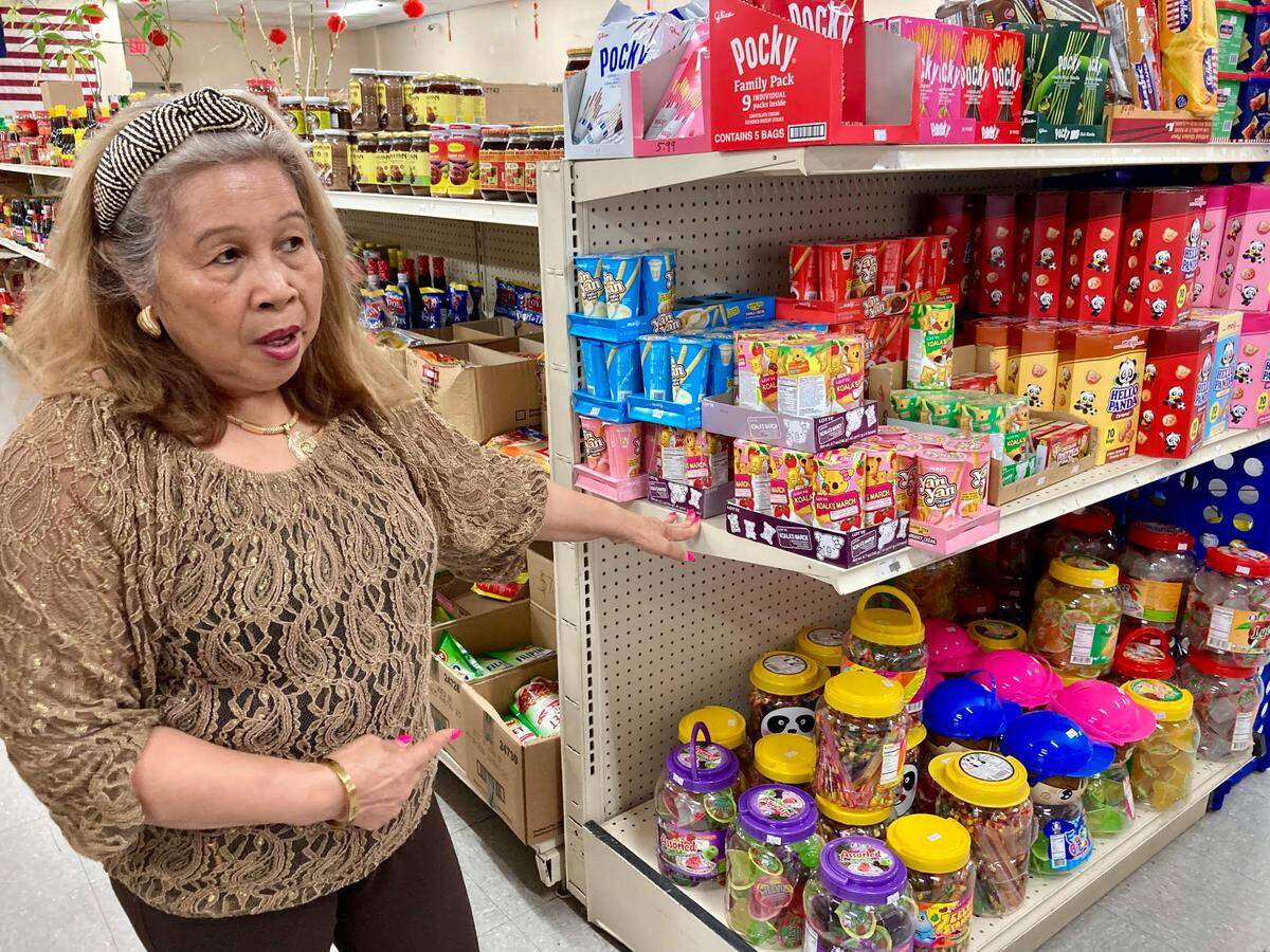 Hermie McMahon, who runs the AB&C Oriental Store in Warner Robins, points to a shelf of popular Asian candies.