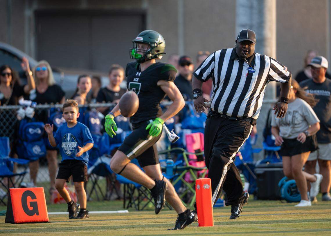 ACE receiver Brice Whitley (7) delivers the ball to an official after scoring a touchdown in ACE’s 48-0 victory over GMC Friday night..