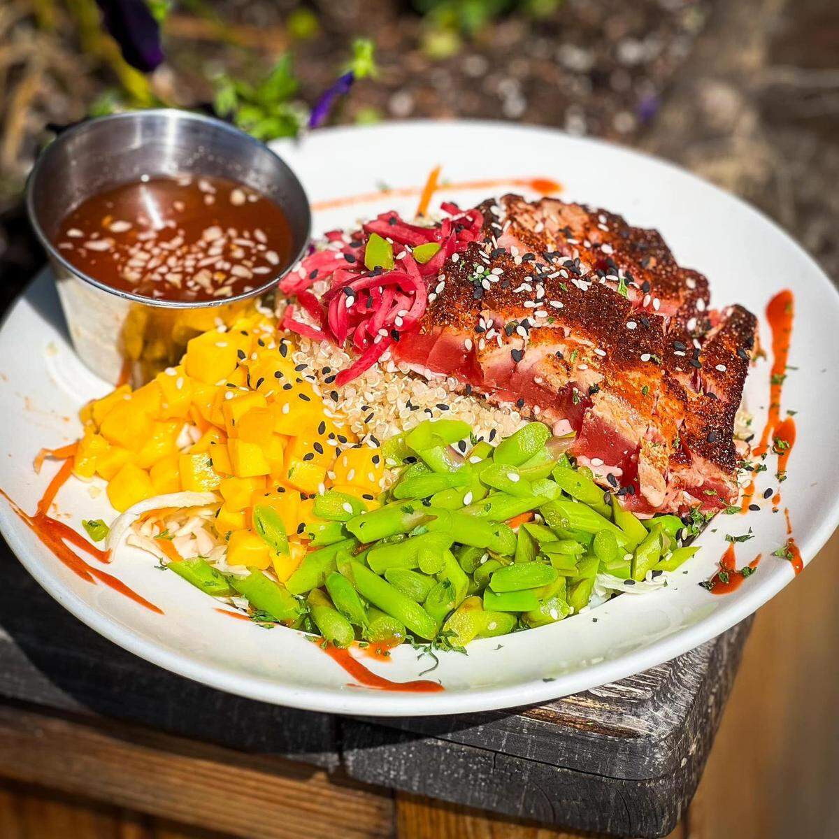 Beautifully seared ahi tuna with a cabbage, quinoa, white rice, asparagus and mango topping and a mirin ginger vinaigrette is just one of the delicious menu items at FOJ in Macon.