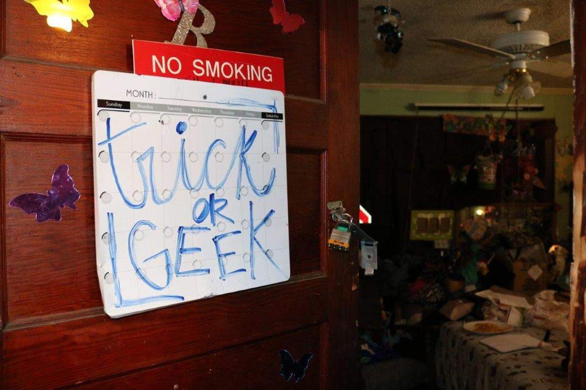 A handwritten sign on a door in the Burton Street house in west Macon where Stewart Leslie Gordon Jr. was shot and killed on Halloween night in 2017.
