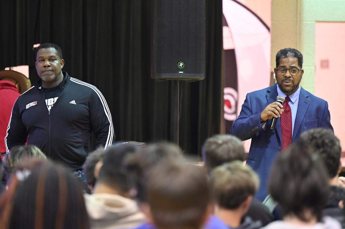 Byron Middle School principal Vosalowe Cammack (right) speaks with Reclaiming Ground Inc. president Willie Raines at the conclusion of an annual anti-bullying assembly in the gymnasium on Thursday, April 9, 2026, in Byron, Georgia. Byron Middle School hosted Raines’ Combat Bullying Tour which stressed suicide prevention and anti-bullying. 