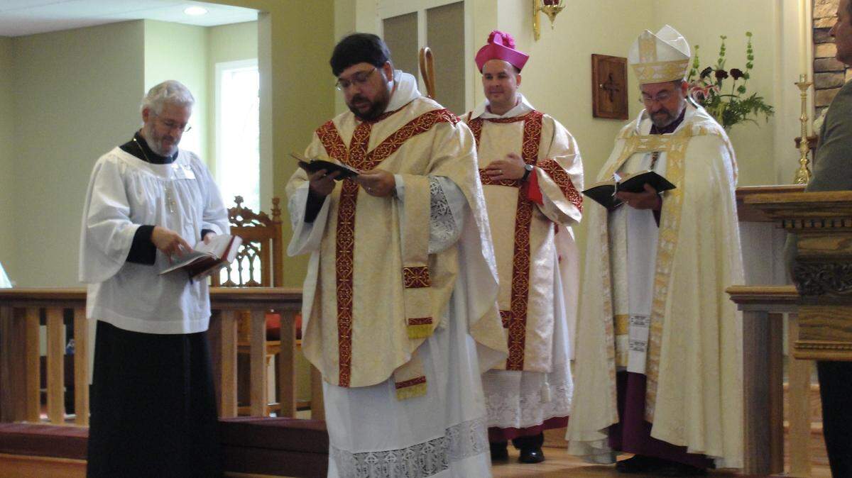 SPECIAL TO THE SUN NEWSFrom left, Senior Warden Clyde Wilkins, Father Matt Harlow, Bishop Chad Jones, Bishop Walter Grundorf and Junior Warden David Selby participate in the ceremony making Harlow the new rector of Christ the Redeemer Anglican Church.