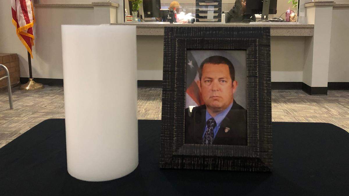 A tribute to Sgt. William “Bill” Gay sits in the lobby of the Bibb County Sheriff’s Annex Building after his death from COVID-19.
