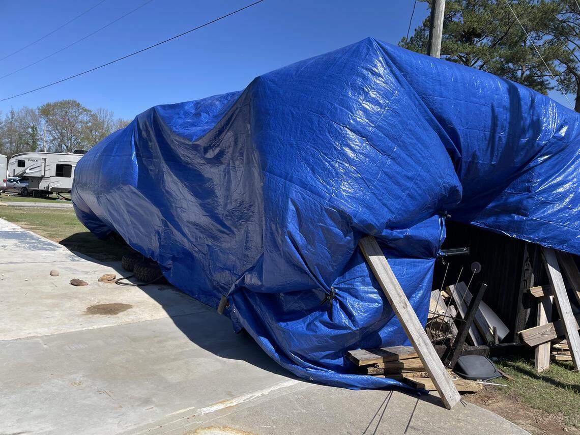 Blue tarp covers a camper that was overturned at the Ponderosa RV Park off Ga. 96 by what was initially believed to be straight line winds but has now been a confirmed as a tornado during a severe thunderstorm early Thursday, March 12, 2026.
