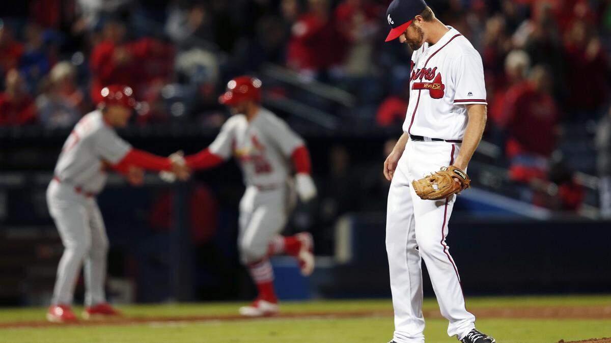 Atlanta Braves starting pitcher John Gant (52) stands on the mound as St. Louis Cardinals' Greg Garcia (35) rounds the bases after hitting a home run in the ninth inning of Friday's game.