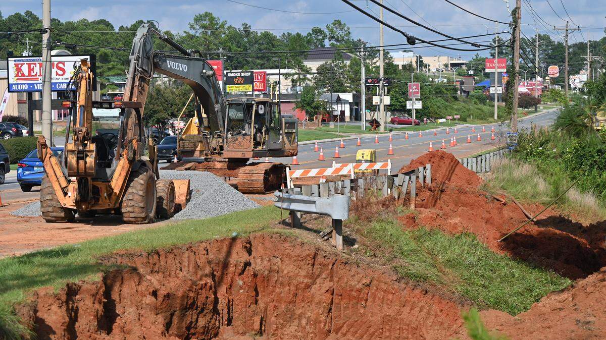 Excavators sit on the side of Watson Boulevard on Wednesday, Aug. 20, 2025,  in Warner Robins, Georgia. A sinkhole opened underground off of Watson Boulevard last Tuesday, which closed lanes and turned off water connected to the damaged water line in order for crews to work on repairs. 