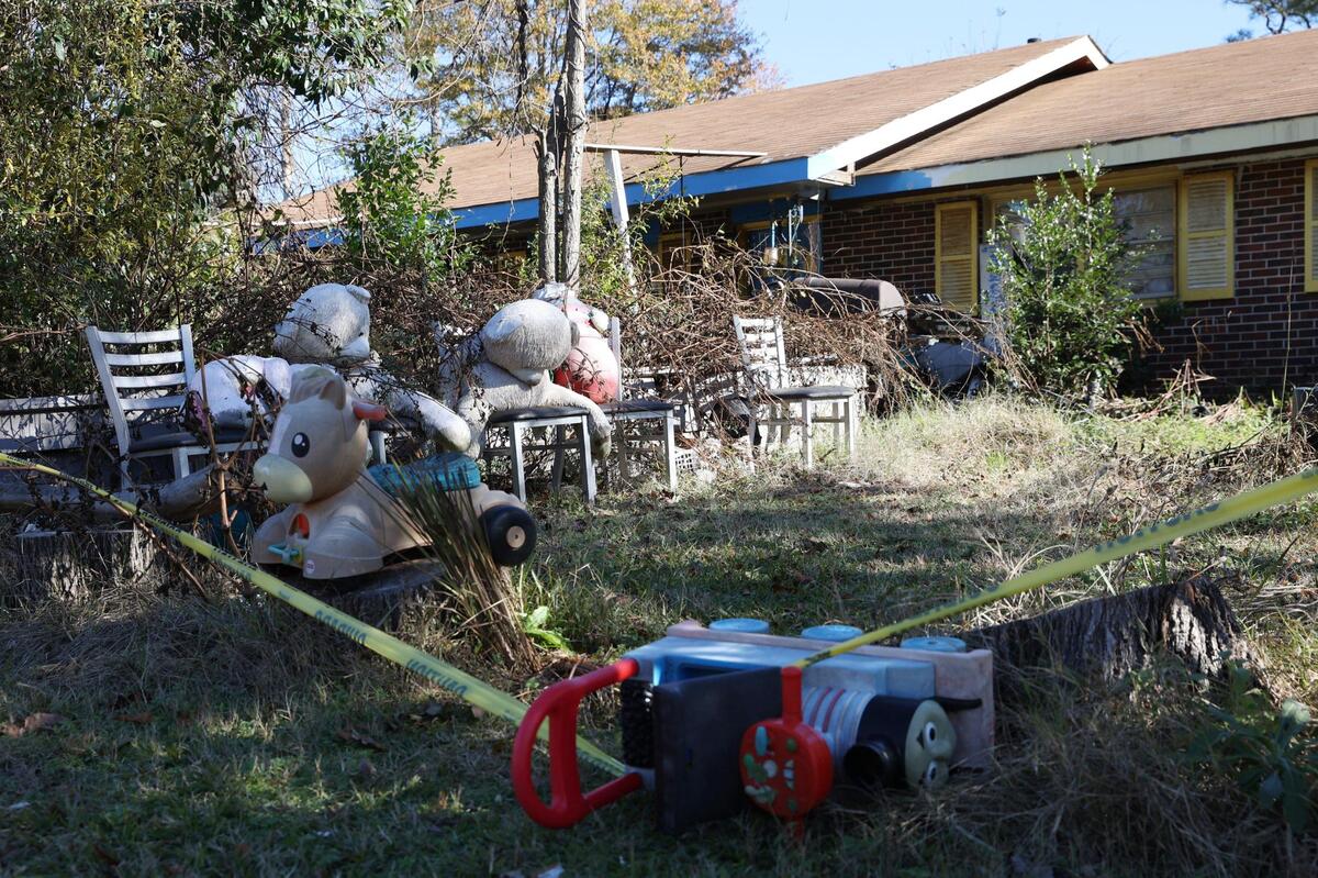 Various items, including children’s toys and furniture clutter the front yard of a condemned property on Angus Boulevard on Thursday, Dec. 12, 2024, in Warner Robins, Georgia. The city of Warner Robins has condemned the residential property because of a severe rat infestation on the property. Neighbors say the house has been in disrepair for years.