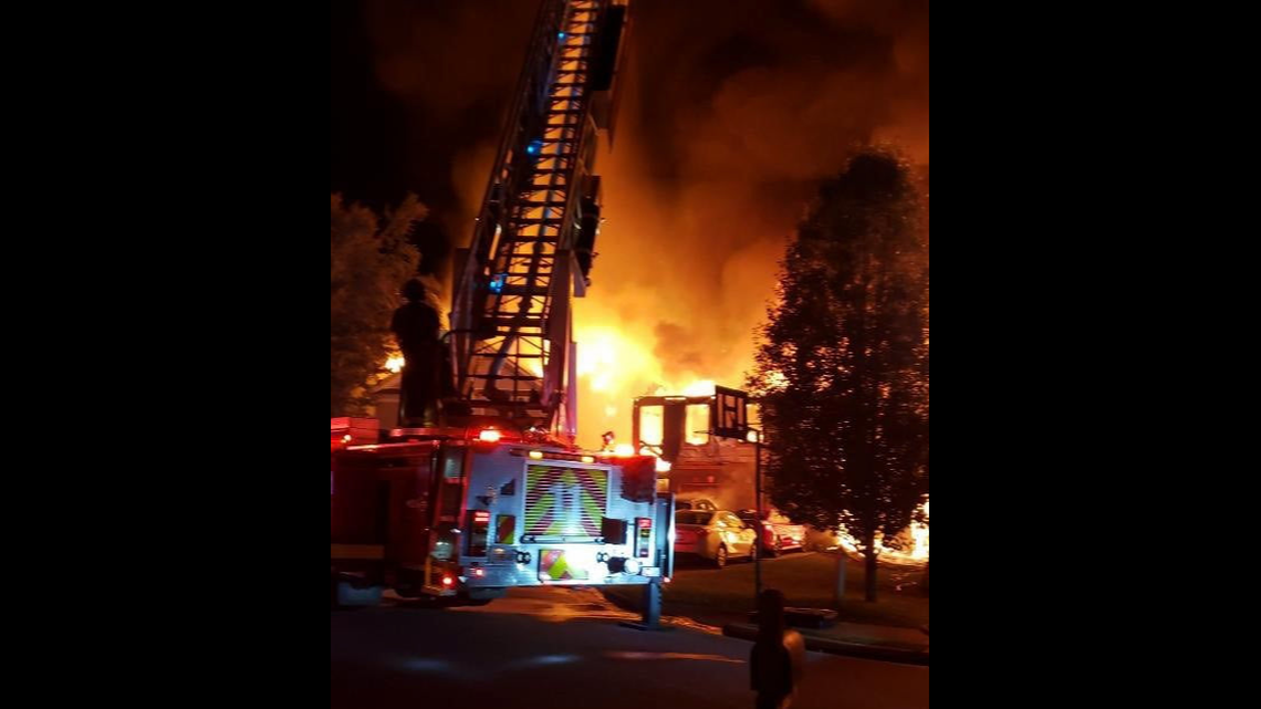Fire officials say a 15-year-old alerted his family and neighbors to a fire that destroyed three homes in a Georgia neighborhood Wednesday morning.