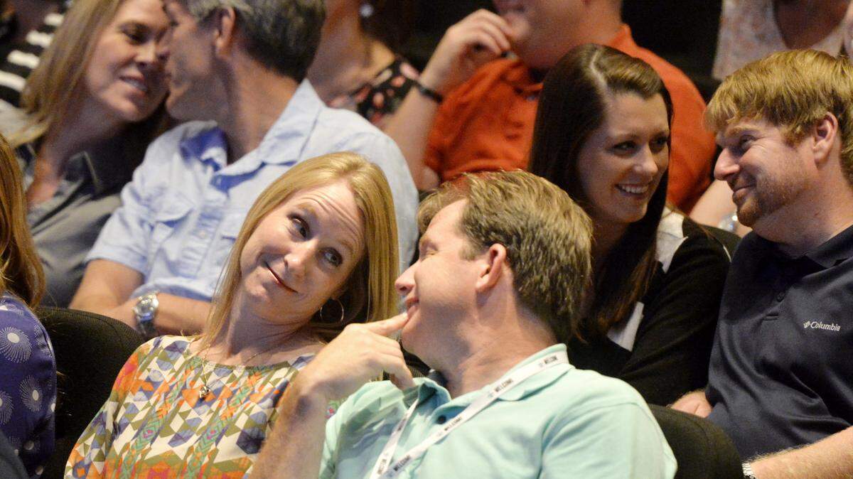Couples have a brief conversation while listening to Parrott speak Sunday evening.