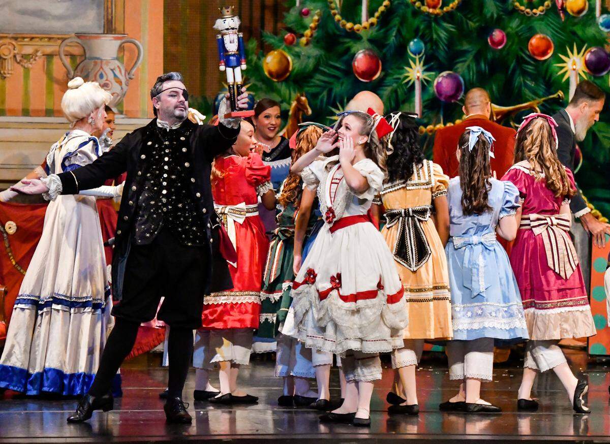 Chris Abbott as “Drosselmeyer” and Carly Blackwood as “Clara” perform with the cast of the Nutcracker of Middle Georgia during a school performance Thursday morning at The Grand Opera House.