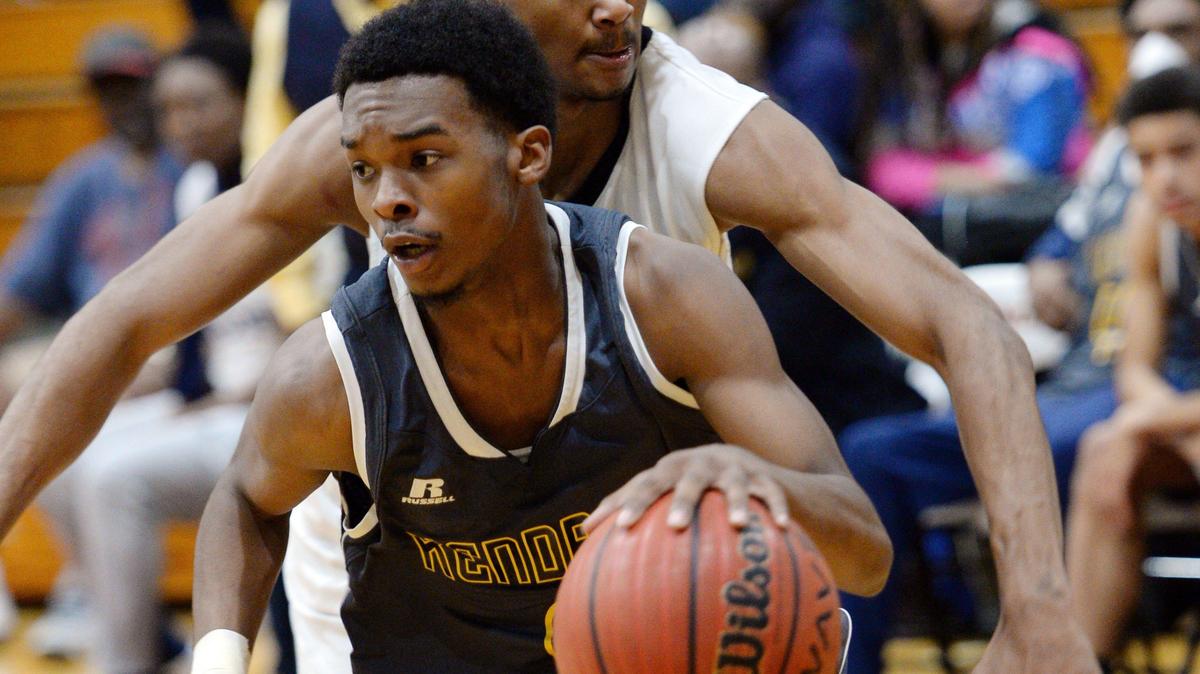 Kendrick’s Que Hall (1) tries to make his way around Westside’s Javian Mosley (22) as he heads for a layup Thursday night. Westside beat Kendrick, 71-48.
