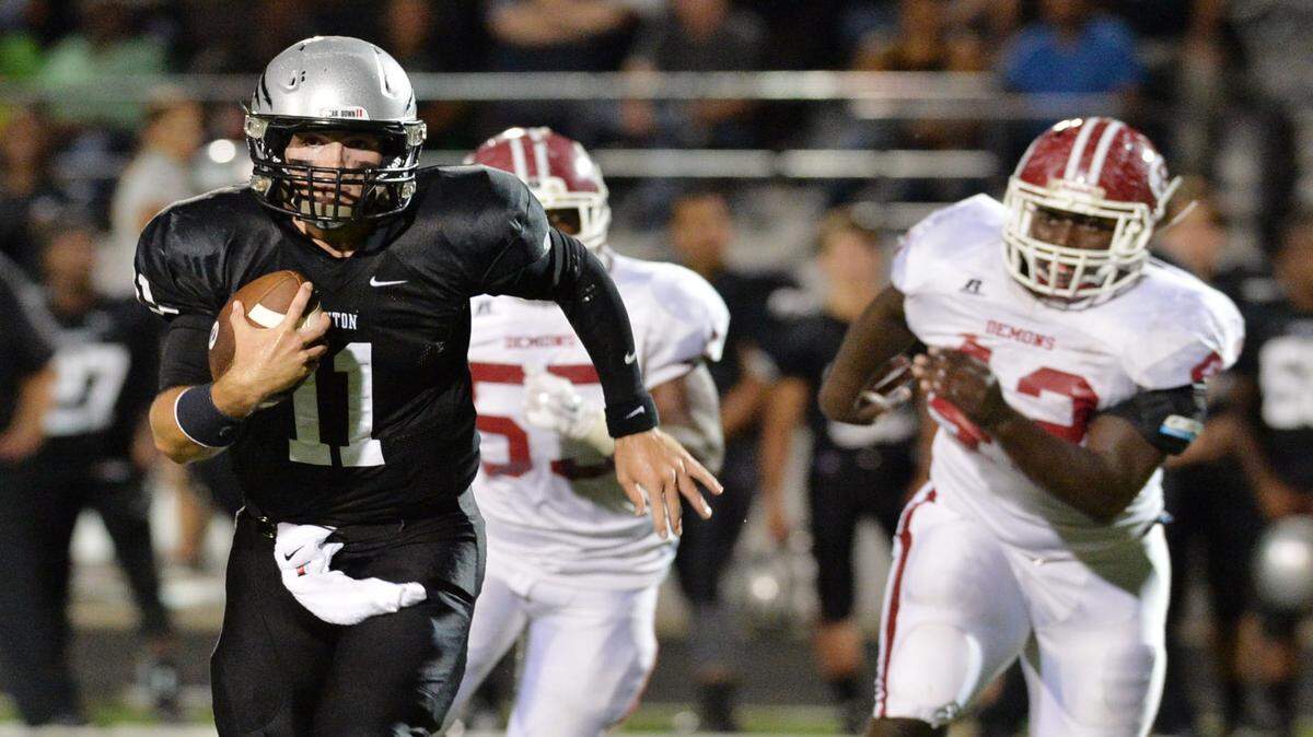 Houston County quarterback Jake Fromm scrambles away from Warner Robins defenders for a first down.