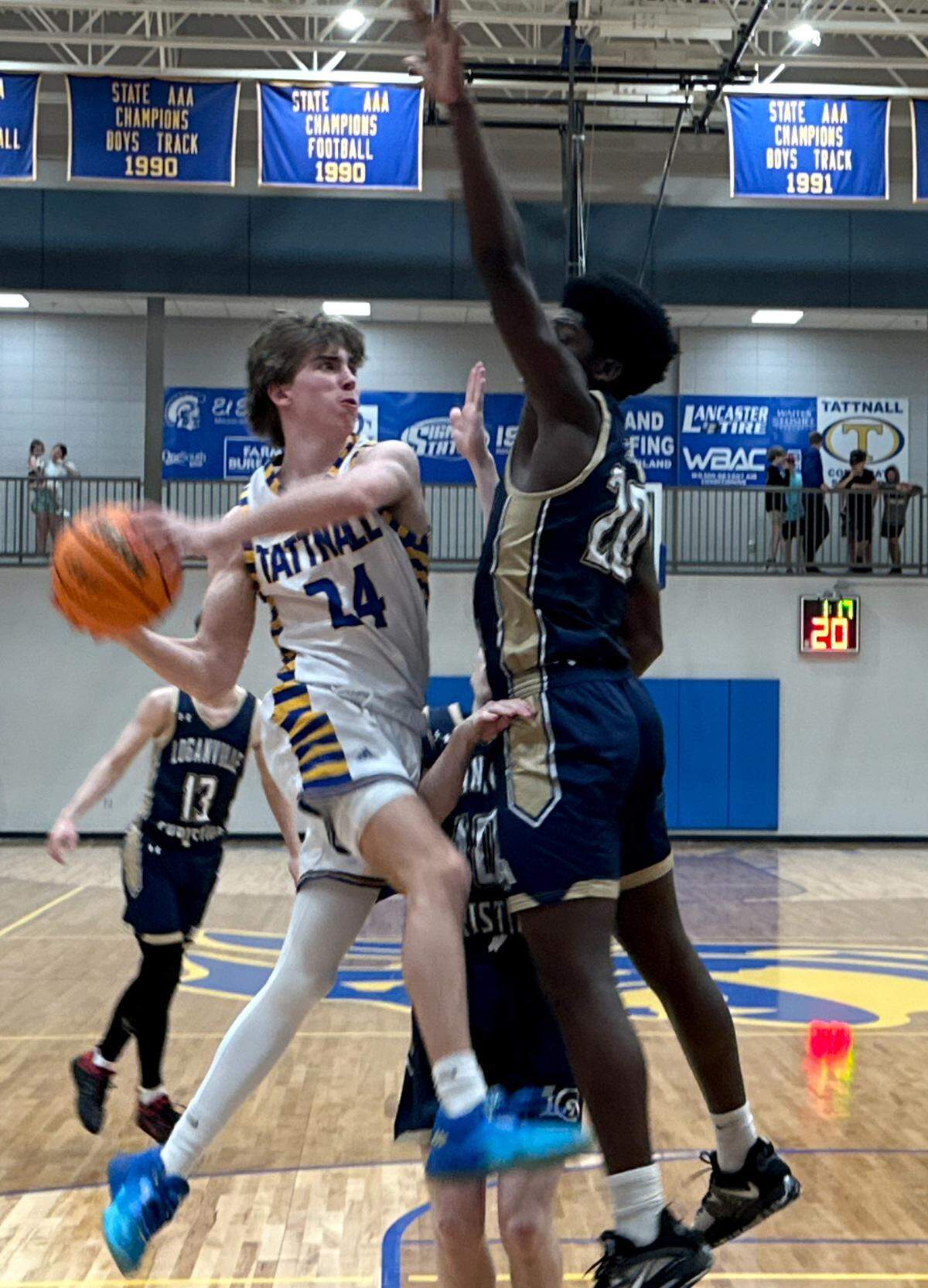 Tattnall’s Ty Hunnicutt (24) passes the ball around a Loganville Christian defender during their GIAA quarterfinal game Saturday.