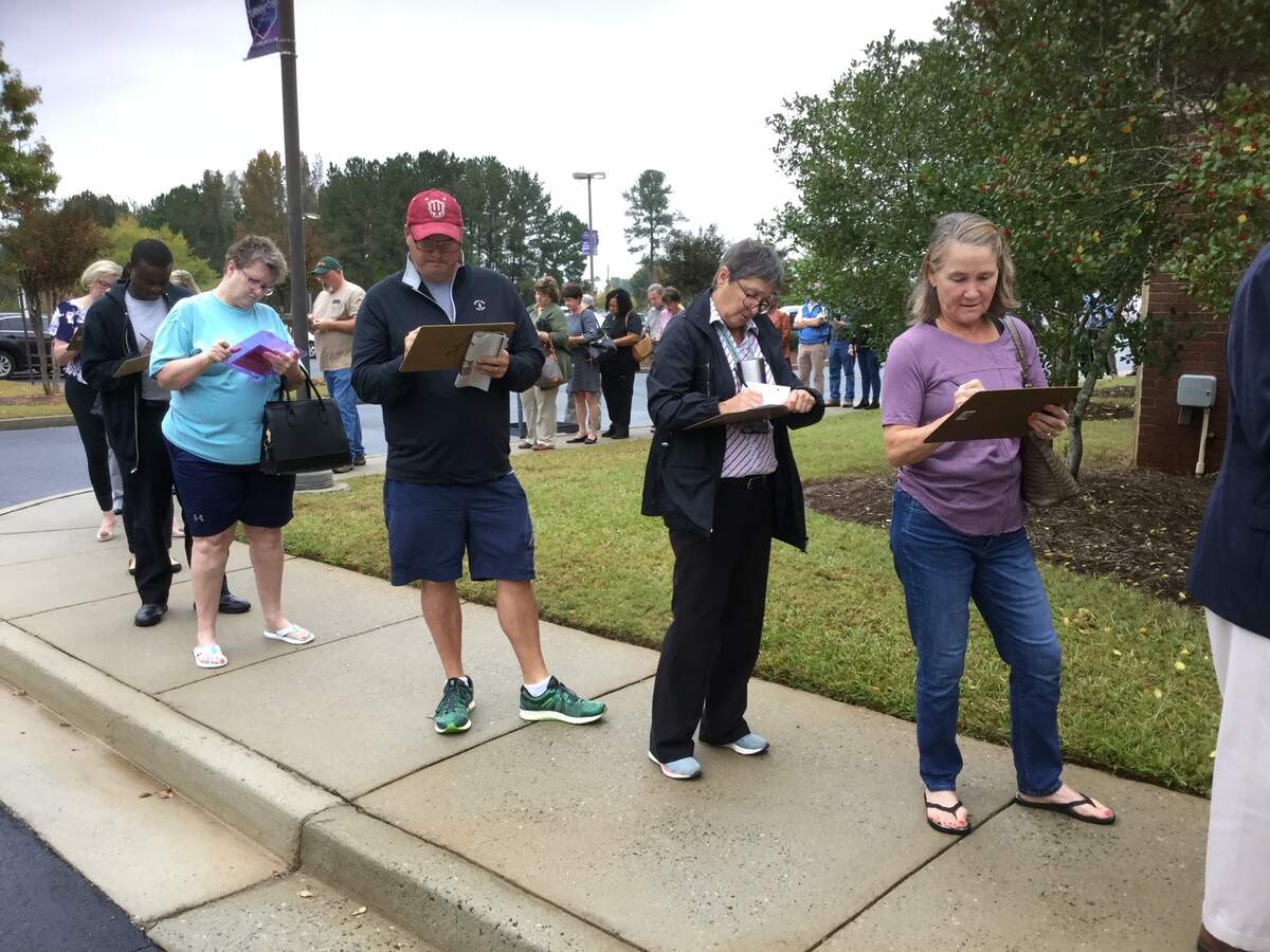 About 50 people line up outside Mabel White Baptist Church on Bass Road to cast their ballots in the midterm election.