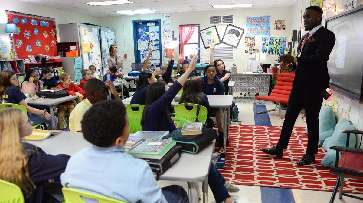 Nnamdi Onyekwuluje, case manager for the School-Justice Partnership program in Macon-Bibb County, right, picks on a student at Springdale Elementary School to answer a question during his talk with the class about making good decisions as they go into middle school. The school is set to be demolished and replaced with a new building at the end of this school year. JENNA EASON/THE TELEGRAPH Macon, GA, 12/05/2019: