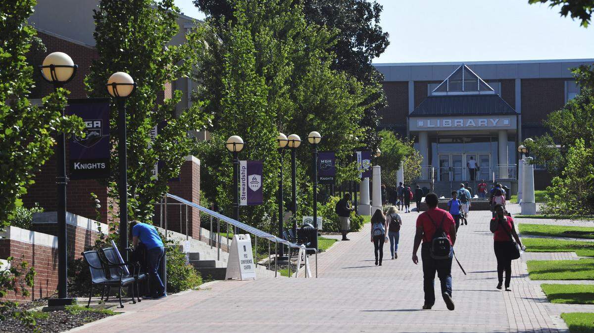 Students walk toward the library at Middle Georgia State University’s Macon campus.