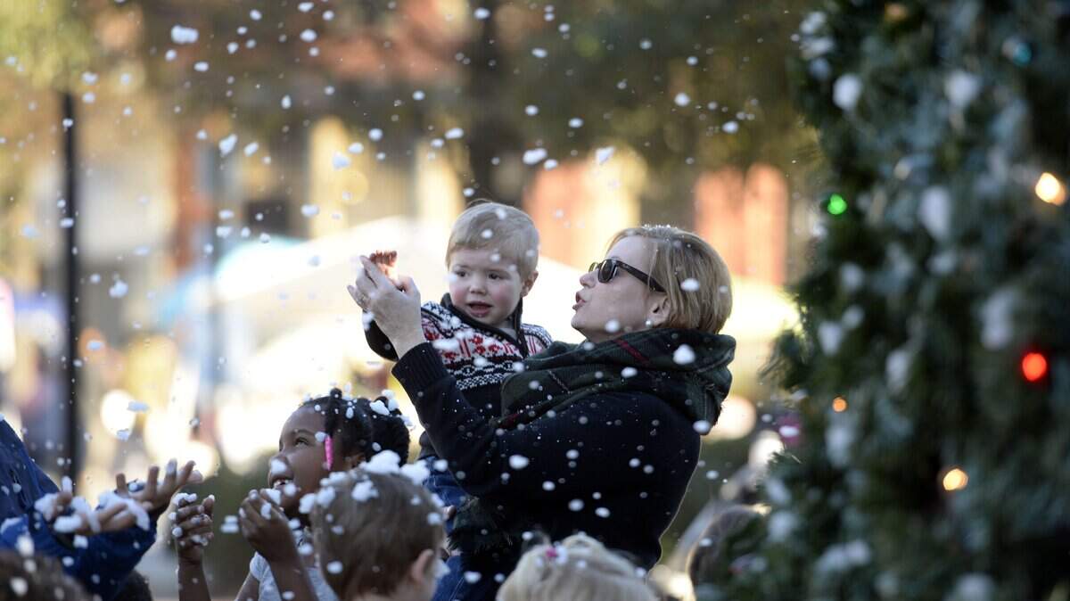 A Cochran family enjoys artificial snow in Rosa Parks Square earlier this month, but forecasters says Macon could see the real thing twice this coming week.