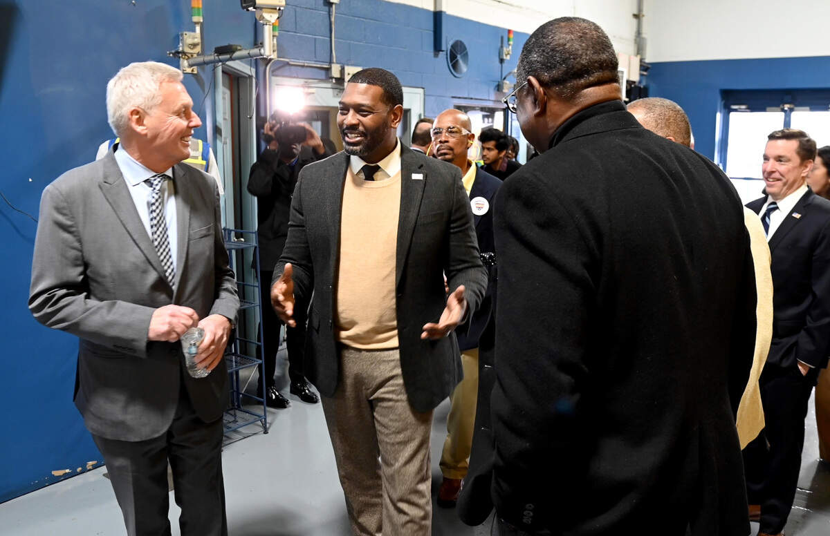 Blue Bird CEO Phil Horlock, left greets EPA Administrator Michael Regan at the company Monday afternoon. Regan announced the latest funding for clean school buses at an event in Dekalb County earlier in the day.
