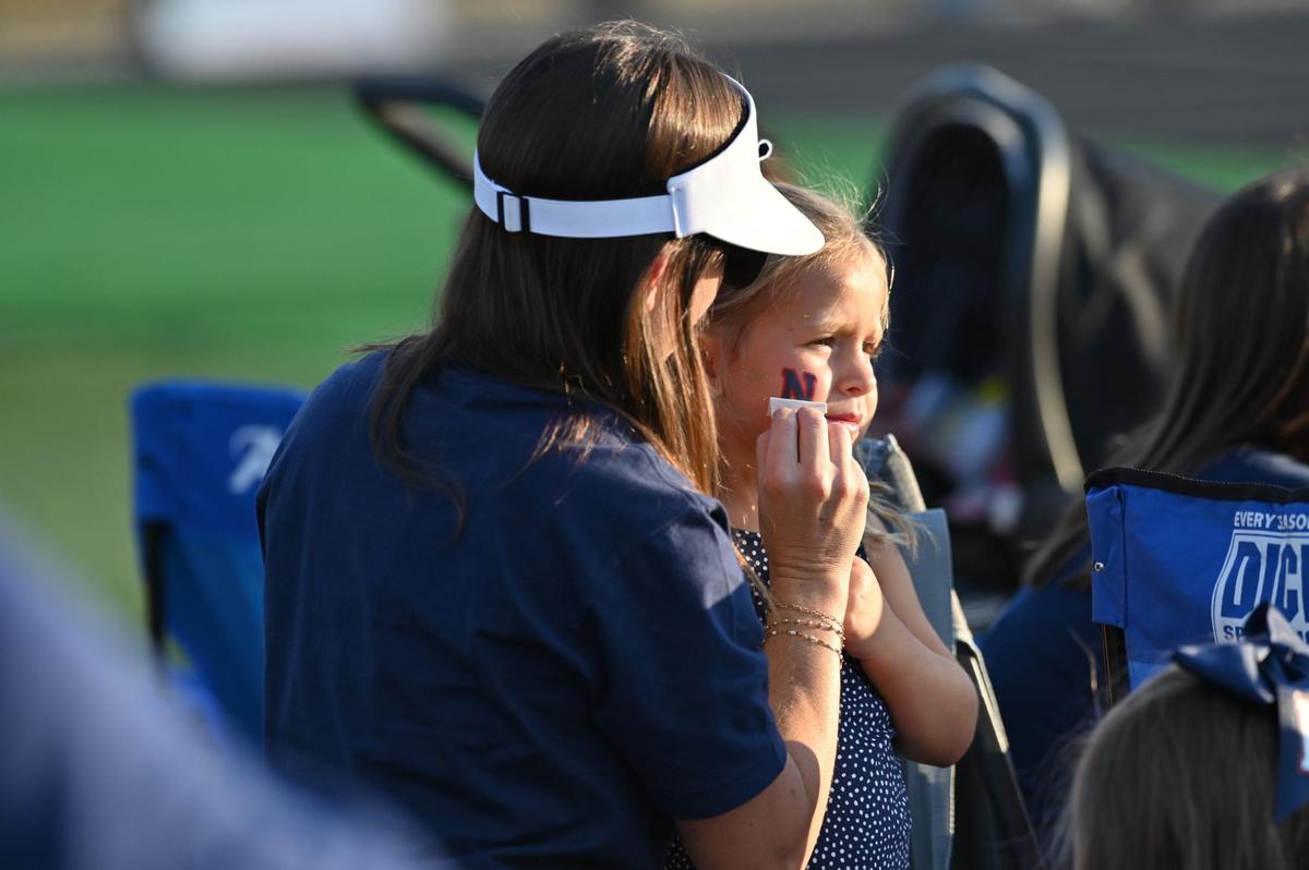 Ansley Bailey puts a Northside High School temporary tattoo on Andi Bailey’s cheek before the start of the football game between Warner Robins and Northside High Schools on Friday, Aug. 30, 2024, at McConnell Talbert Stadium in Warner Robins, Georgia. The Warner Robins High School football team defeated the Northside High School team 34-12.
