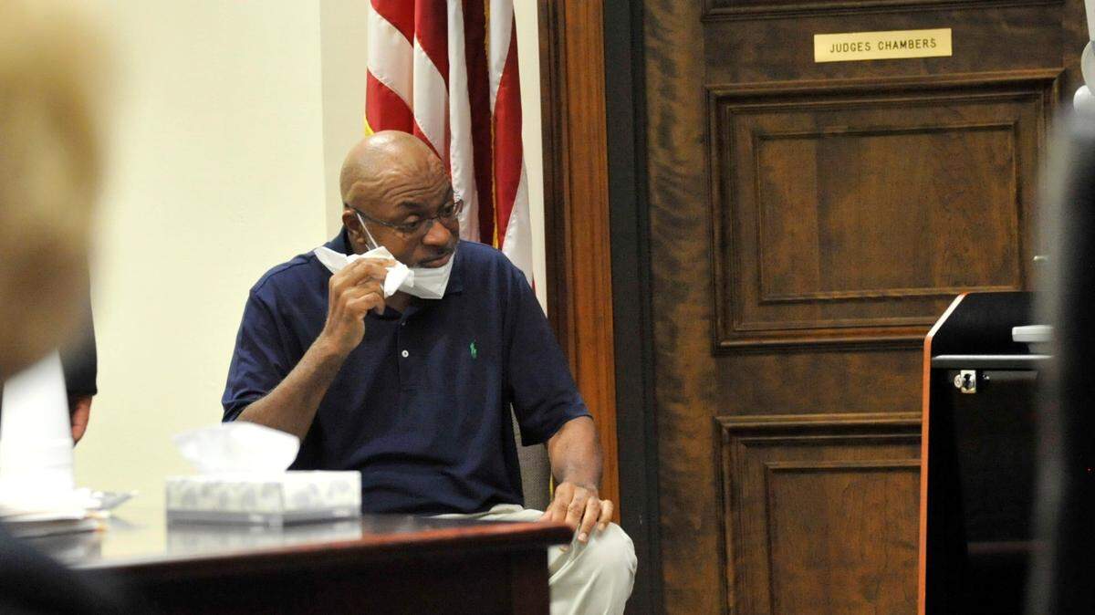 Willie McKinley Hill wipes tears from his eyes during a hearing in Bibb County Superior Court on Monday, where he pleaded guilty to the August 2020 shooting and wounding of his 17-year-old son.