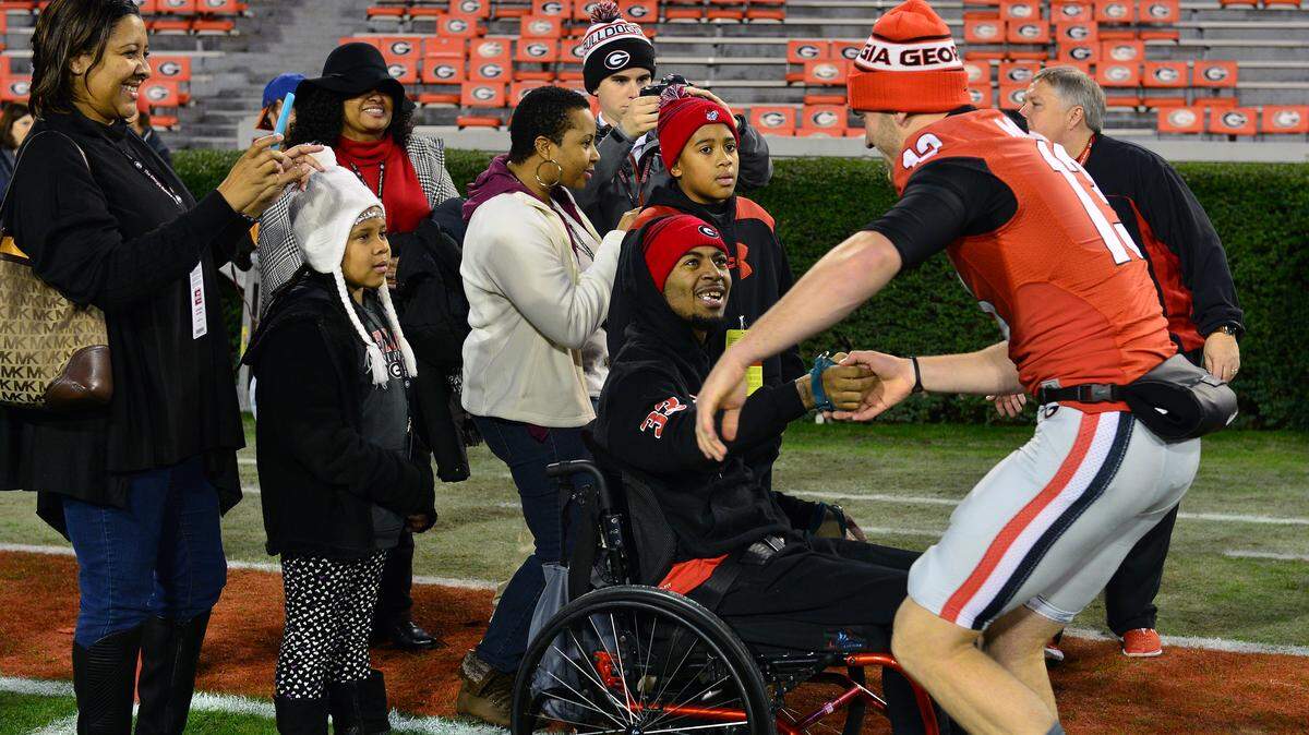 Devon Gales shakes hands with Georgia place kicker Marshall Morgan (13) during a Dawg Walk in 2015.