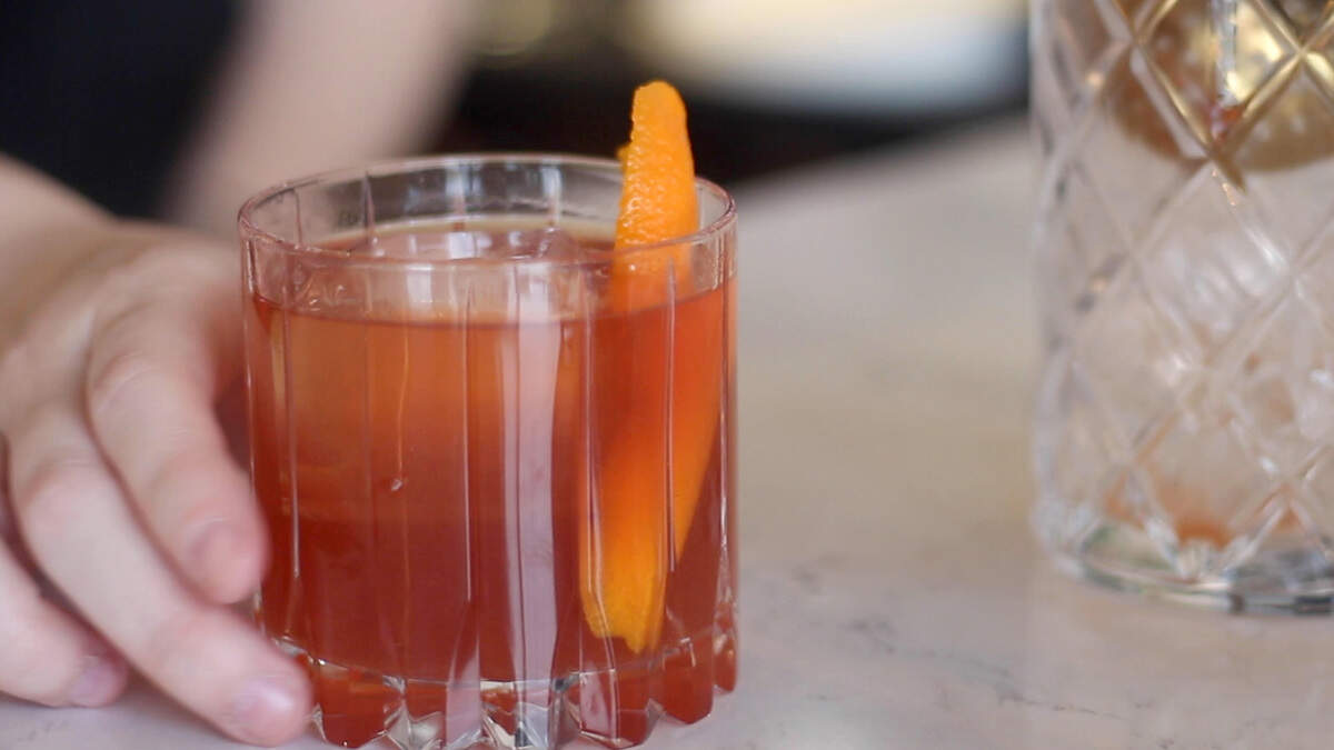 Taylor Couey, a bartender at Kinjo Kitchen + Cocktails, makes a specialty drink called Terry’s Chocolate Orange Negroni.