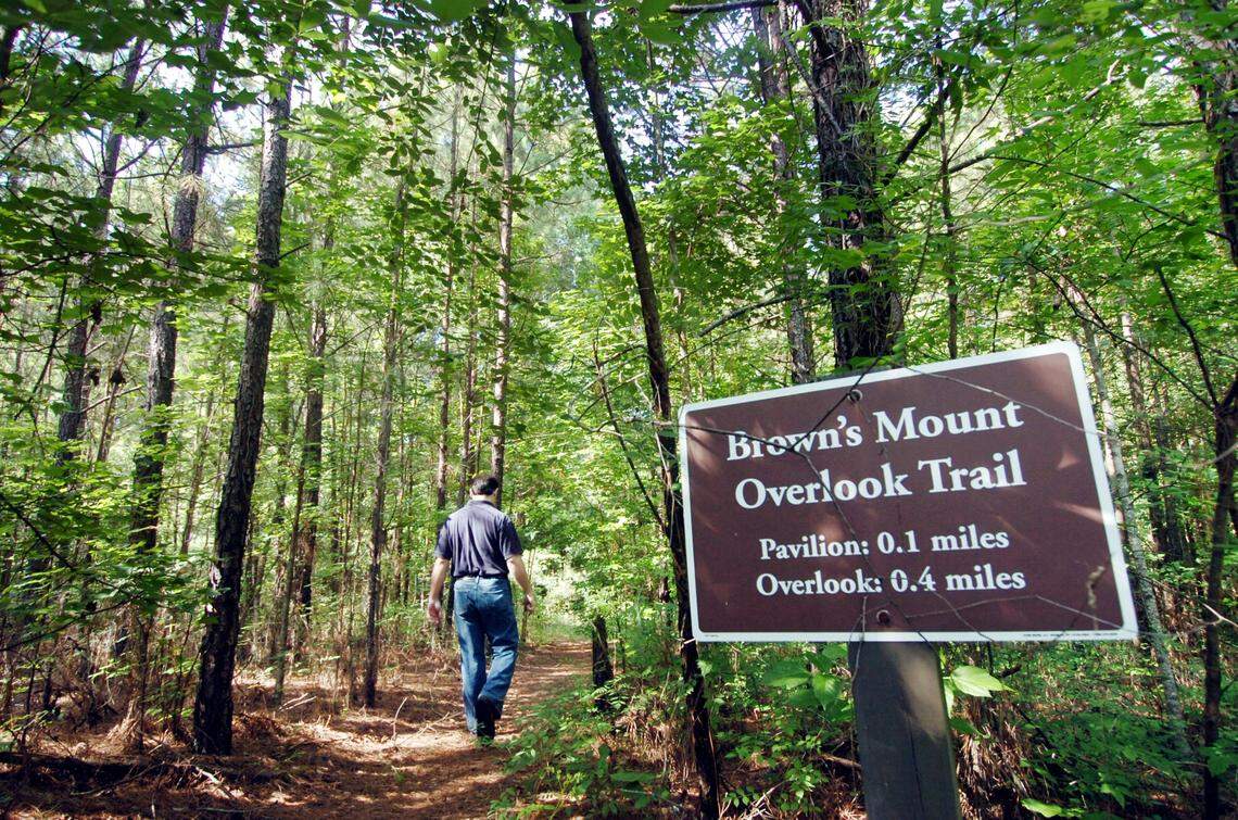 Photo by Beau CabellMacon, Ga., 6/7/06:  Andrew Blascovich, who has guided people through the natural splendor of Brown’s Mount for more than a decade, hikes down a path toward the overlook.  