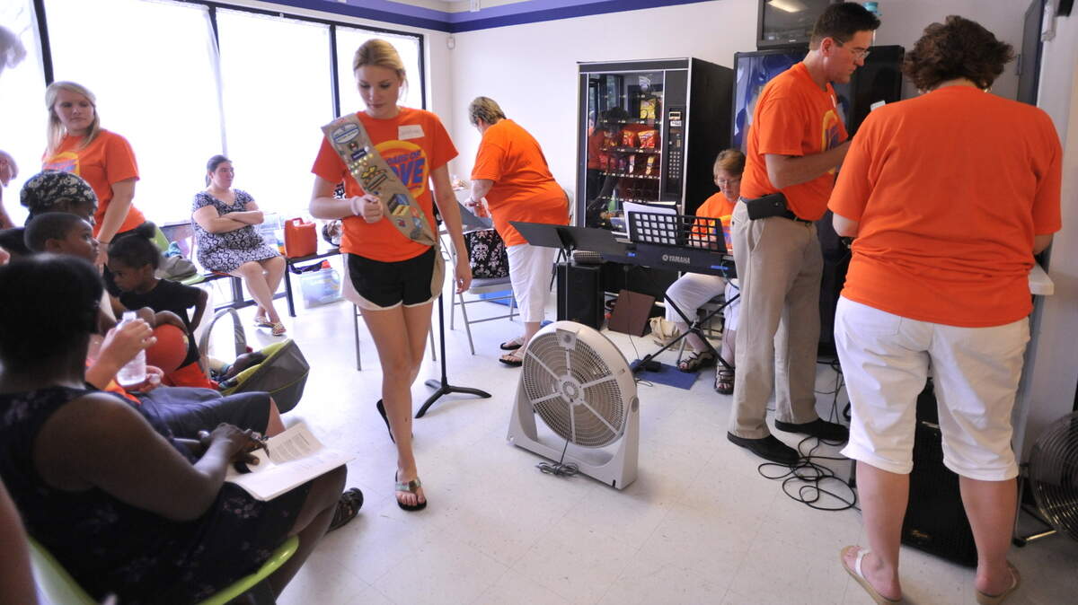 Caroline Gowan, right, organized a laundry night once a month called Loads of Love that allows people from the community to do their laundry for free at Git-R-Dun Too laundromat in Warner Robins.