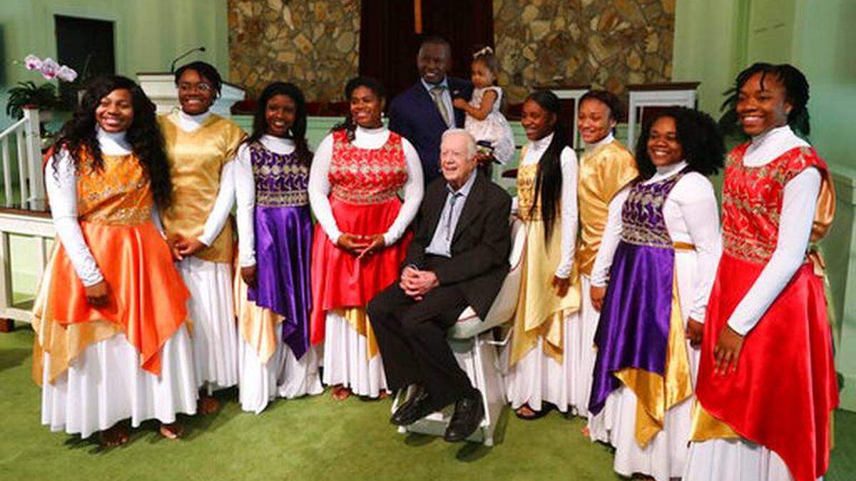 Former U.S. President Jimmy Carter poses for a photo with the Hayiya Dance Theatre troupe from Macon after they performed Sunday at his church in Plains.