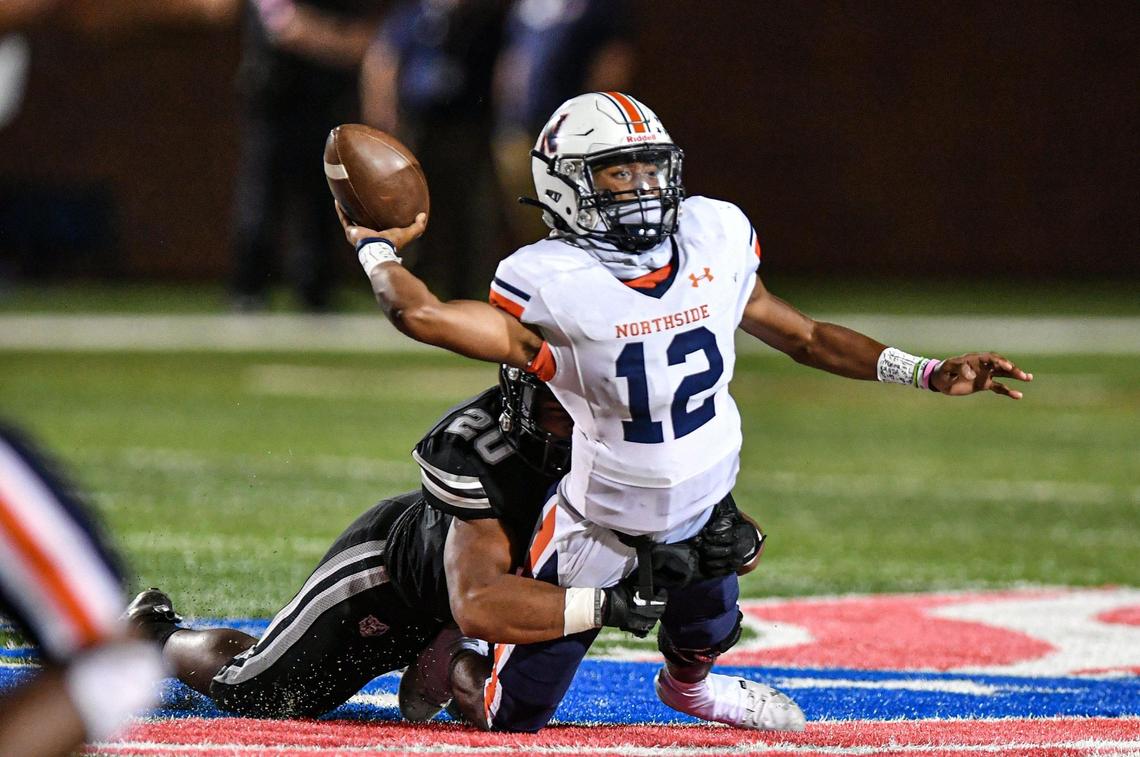 Northside quarterback Damien Dee gets sacked by Houston County defensive end Jaydon Phillips in action Thursday night as Northside defeated Houston County 21-17.