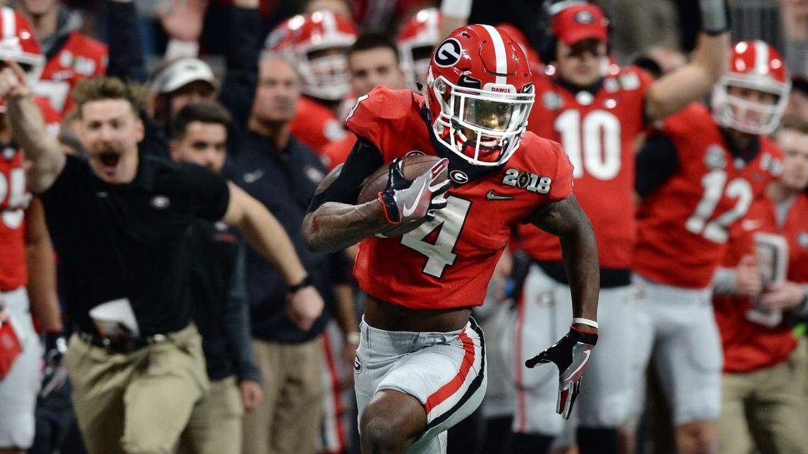 Mecole Hardman scampers past the Georgia bench en route to a touchdown on an 80-yard pass from Jake Fromm.