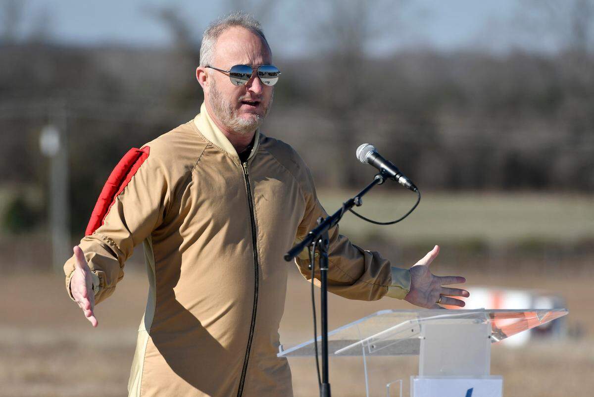 Mayor Lester Miller shows off his jumpsuit while speaking during a groundbreaking ceremony Tuesday for the runway expansion at the Middle Georgia Regional Airport.