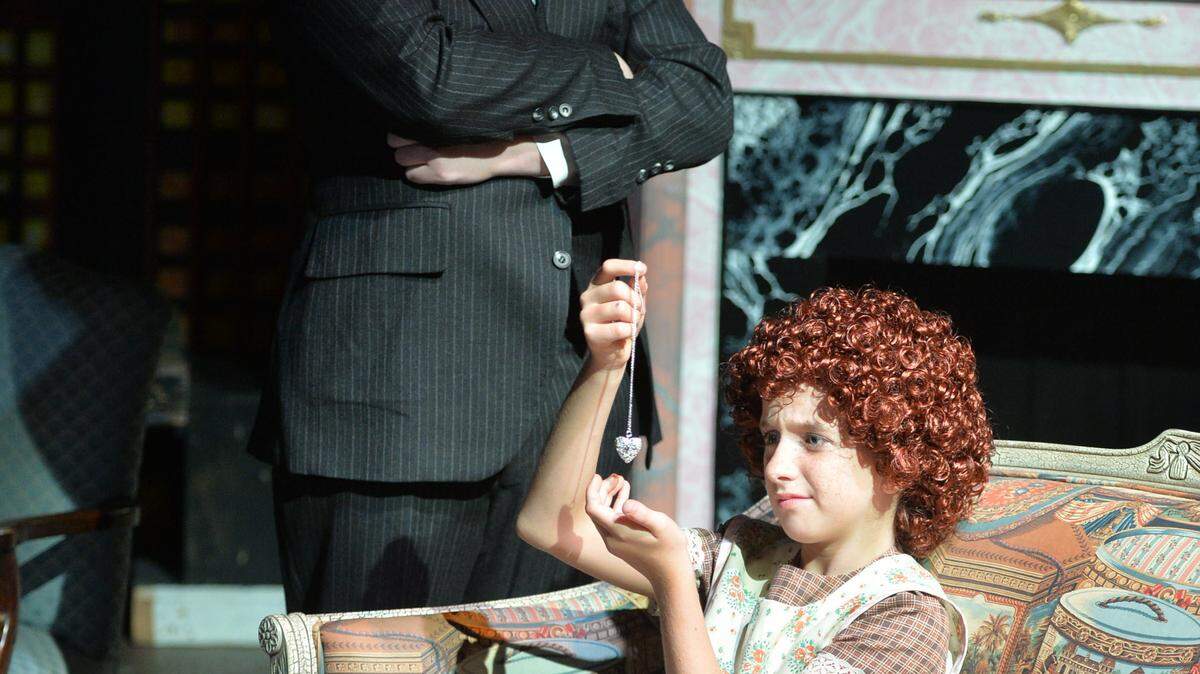 Daddy Warbucks (Jack Finkelstein) gives Annie (Mia Pendergast) a special present in the Youth Actors Company of Theatre Macon's production of "Annie, Jr."
