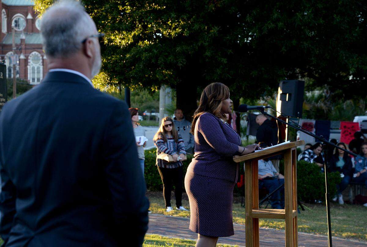 District Attorney Anita Howard, of the Macon Judicial Circuit, speaks Tuesday at a candlelight vigil for Domestic Violence Awareness Month in Rosa Parks Square.