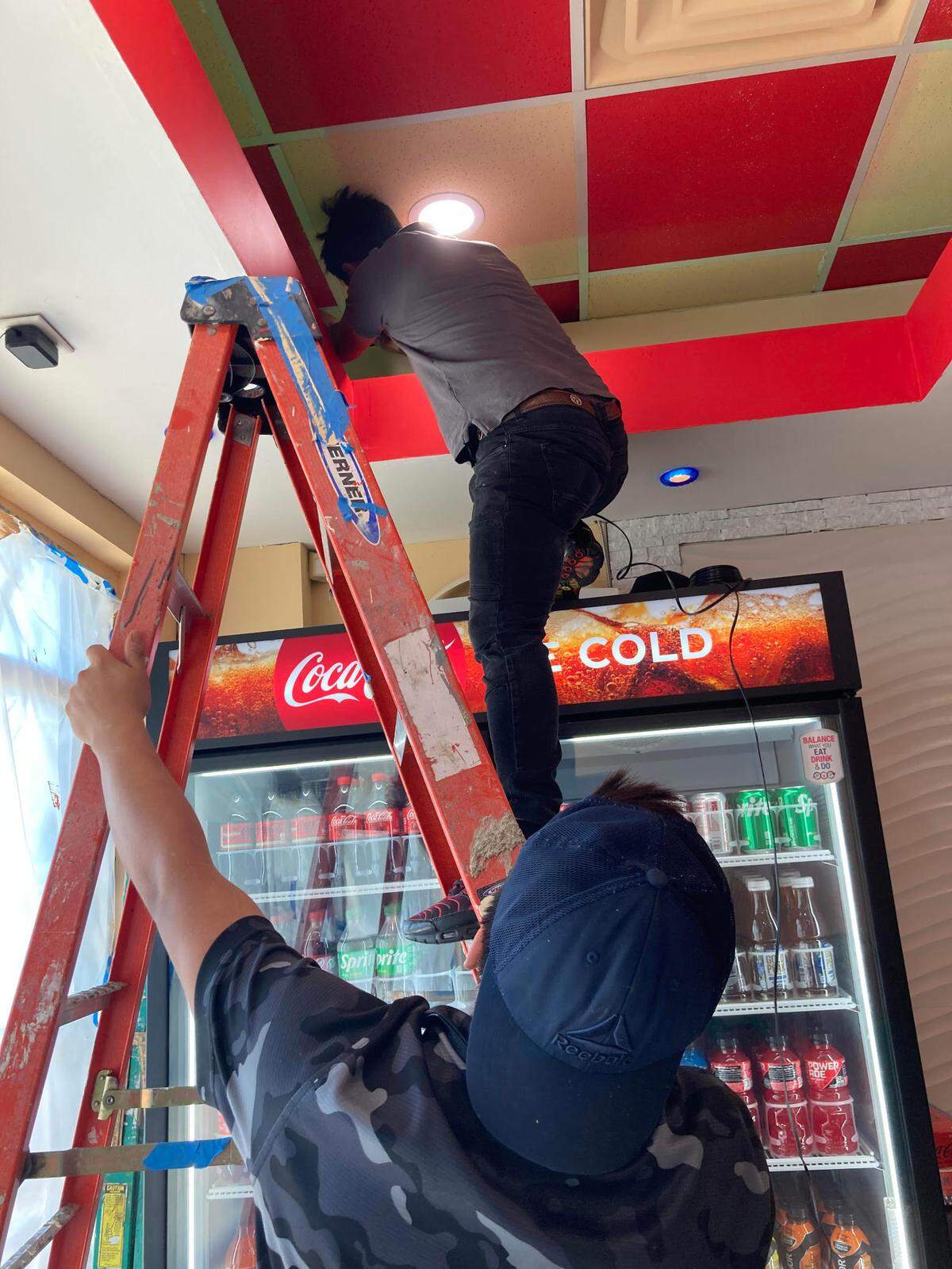 Workers install a security system in the new No Name Burger restaurant to open soon at 778 Ga. 96, Suite 135, next to its sister restaurant, No Name Chicken, in the Kroger shopping center off Ga. 96 in the Bonaire community of Warner Robins.