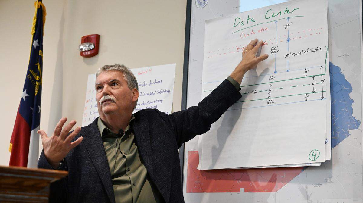 Monroe County District 2 Commissioner Eddie Rowland points to a hand-drawn diagram of a data center buffer during a commission meeting on Tuesday, March 3, 2026, in Forsyth, Ga. The commission voted to table a decision to amend the county’s Unified Development Ordinance (UDO) surrounding data centers until next meeting, so that they could make several changes before voting.
