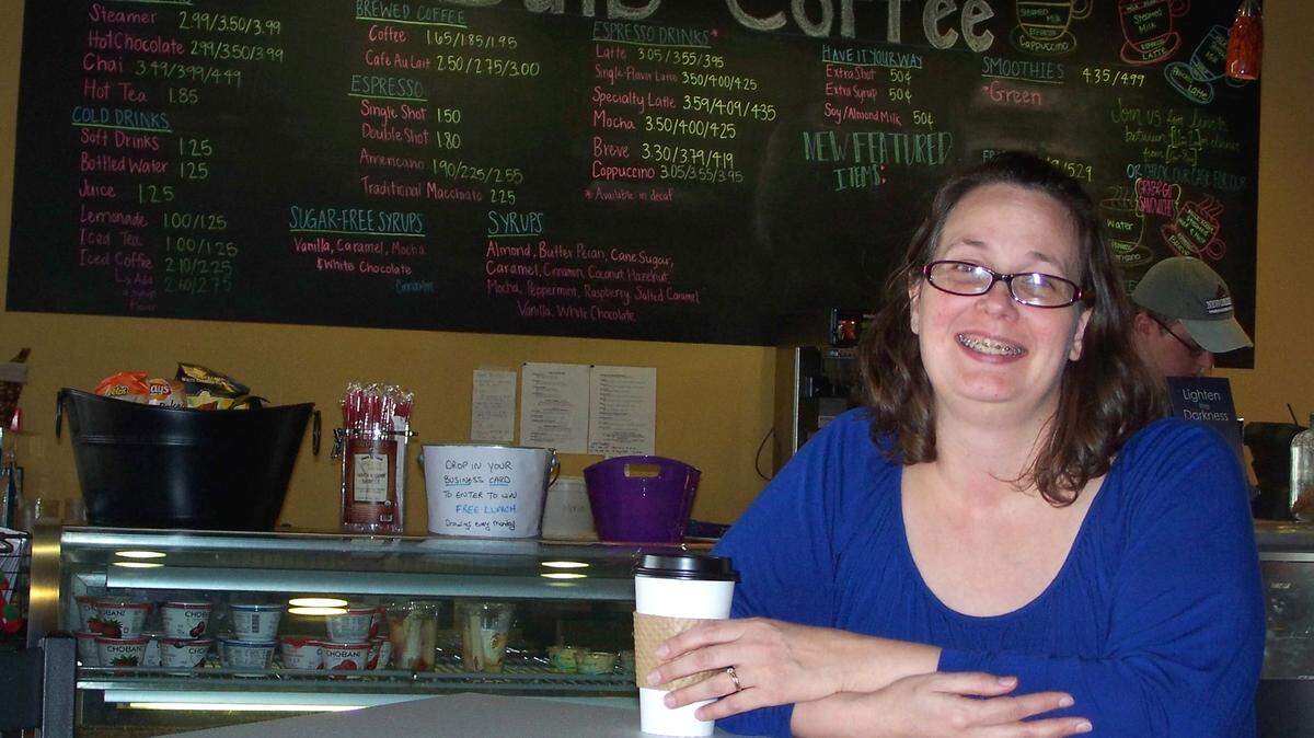 Dena Hobbs, manager, enjoys a cup of java at Bare Bulb Coffee, which will close at the end of January.