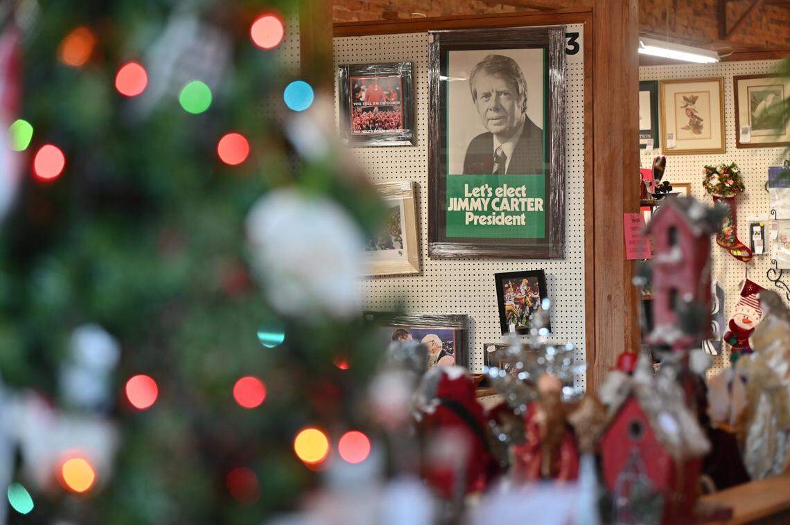 A poster of former president Jimmy Carter hangs inside of Plains Historic Inn and Antique Mall on the day of former president Carter’s funeral in his hometown of Plains on Thursday, Jan. 9, 2025, in Plains, Georgia. A funeral service for Carter was held in Washington D.C. on Thursday morning with an additional funeral service later in the afternoon in Plains, where he will then be buried next to his wife Rosalynn Carter on his family’s peanut farm.